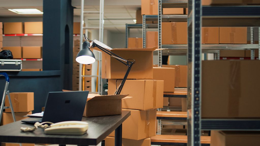 empty storehouse with office desk to work on inventory and logistics