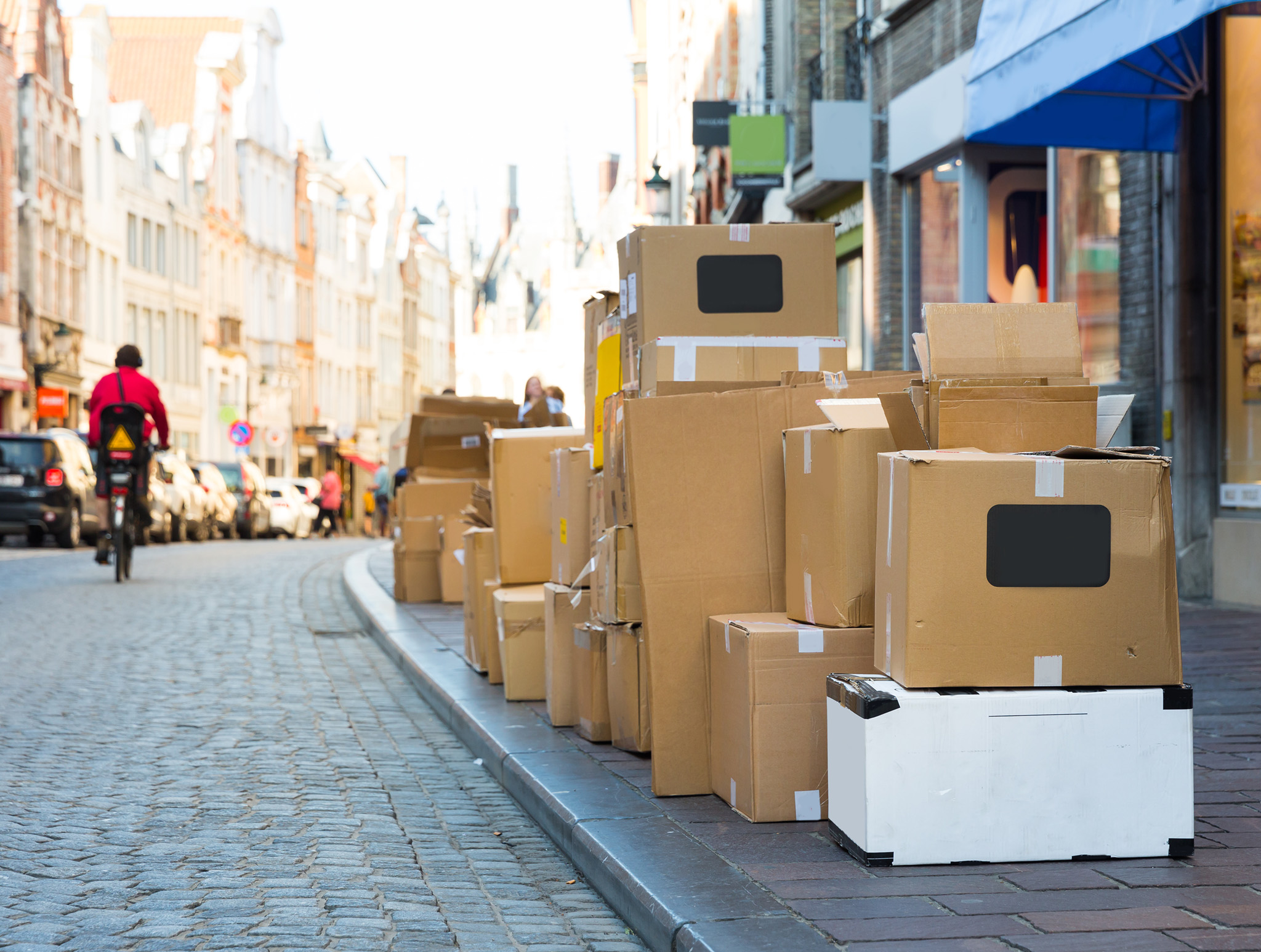 carton garbage boxes on sidewalk, european city